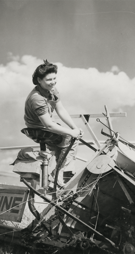 Woman standing on a plow